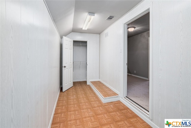 hallway with light parquet flooring and lofted ceiling