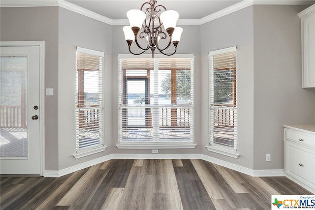 unfurnished dining area featuring dark hardwood / wood-style flooring, a notable chandelier, and crown molding