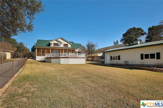 back of house with a lawn