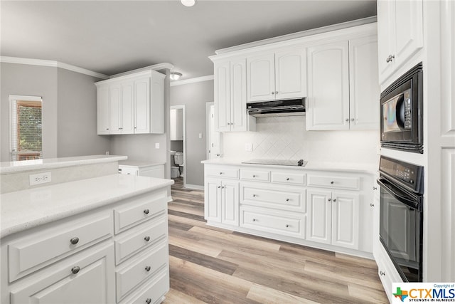 kitchen with ornamental molding, white cabinetry, black appliances, and light hardwood / wood-style flooring