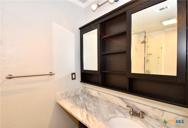 1624 Aquarena Springs Dr Unit G155, San Marcos, TX 78666 - full bathroom with a shower with shower door, ornamental molding, vanity, and a textured wall
