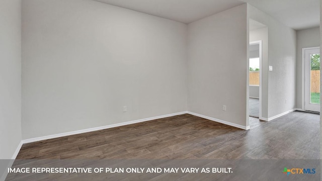 empty room featuring dark hardwood / wood-style flooring