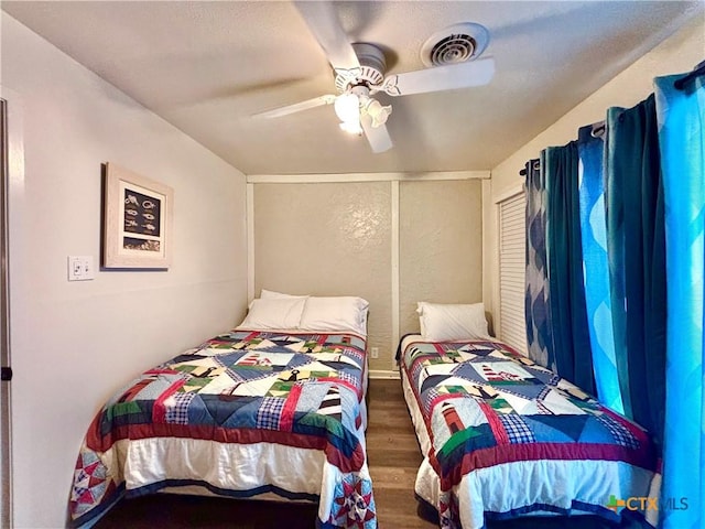 bedroom featuring dark hardwood / wood-style flooring and ceiling fan