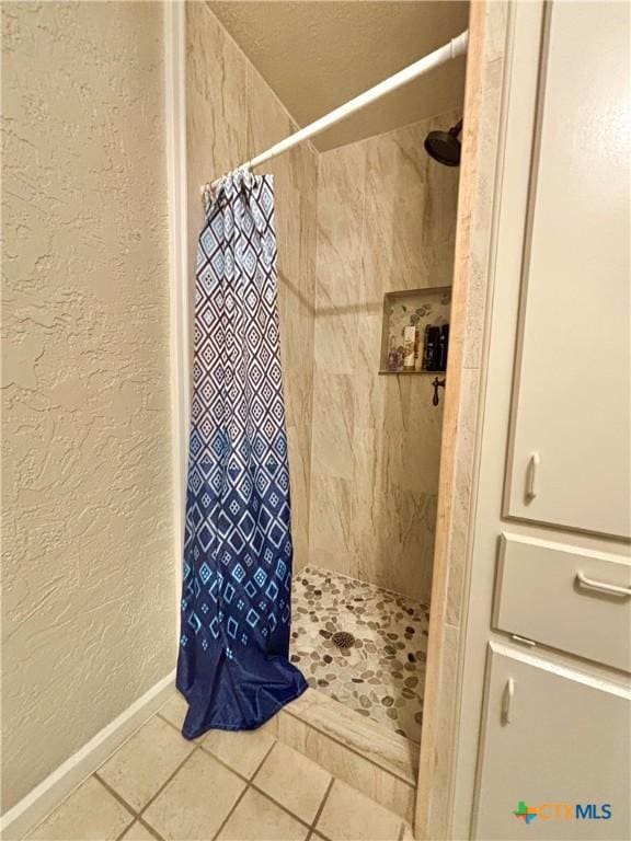 bathroom featuring curtained shower and tile patterned floors