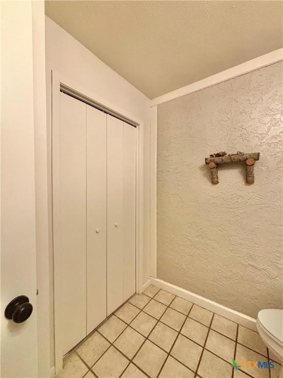 bathroom featuring tile patterned flooring and toilet