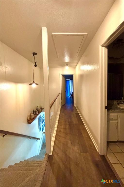 hallway with dark wood-type flooring and sink