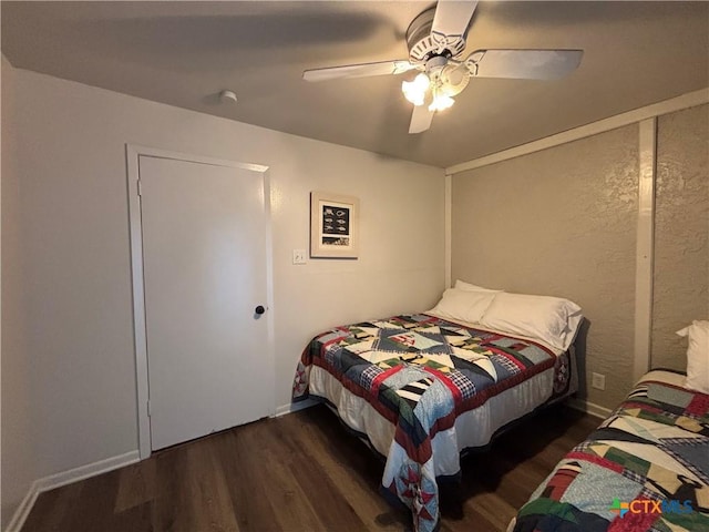 bedroom featuring dark wood-type flooring and ceiling fan