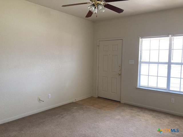 spare room with light carpet and ceiling fan