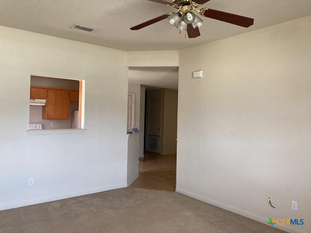 empty room featuring light carpet and ceiling fan