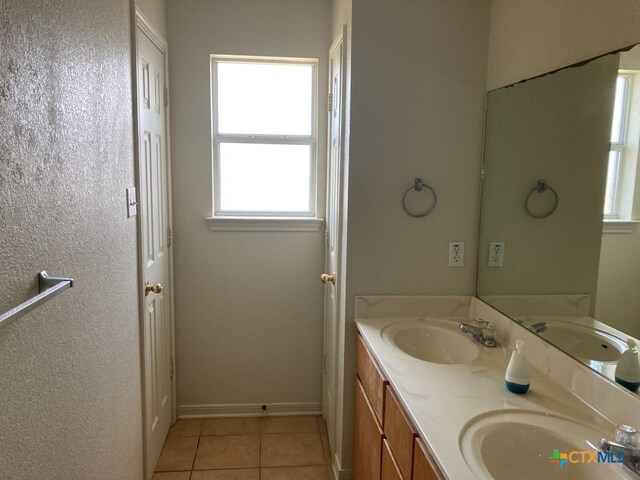 bathroom with tile patterned flooring and vanity