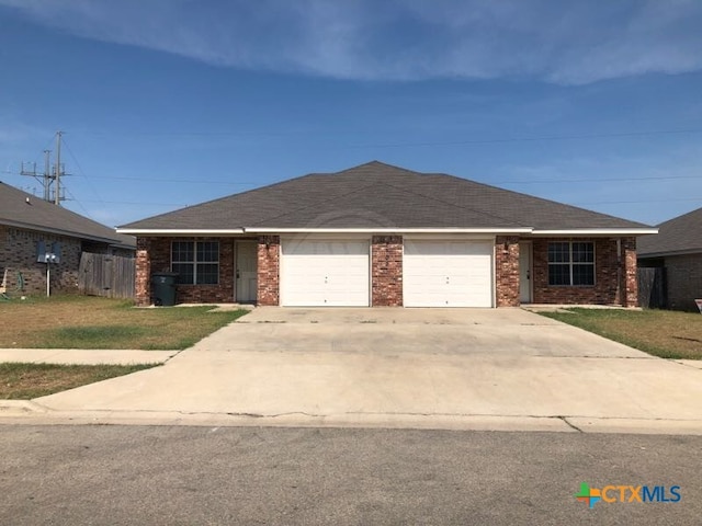 ranch-style home with a garage and a front lawn