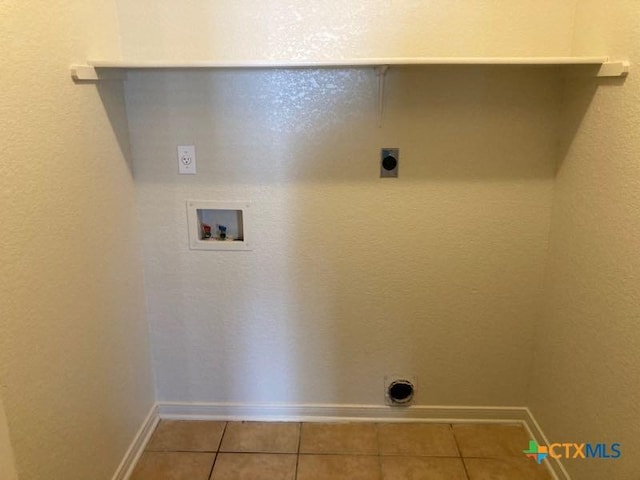 washroom featuring hookup for an electric dryer, light tile patterned floors, and washer hookup