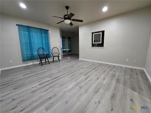 unfurnished living room with ceiling fan and light wood-type flooring