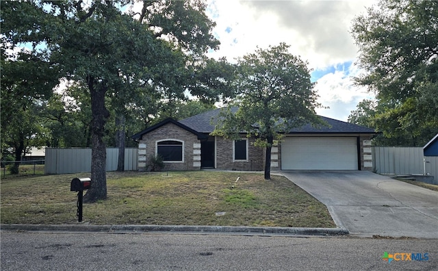 view of front of property with a garage and a front yard