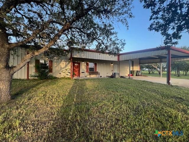 exterior space with a lawn and a carport