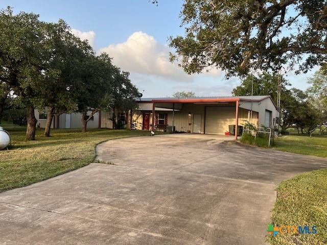 view of front facade with a carport and a front lawn