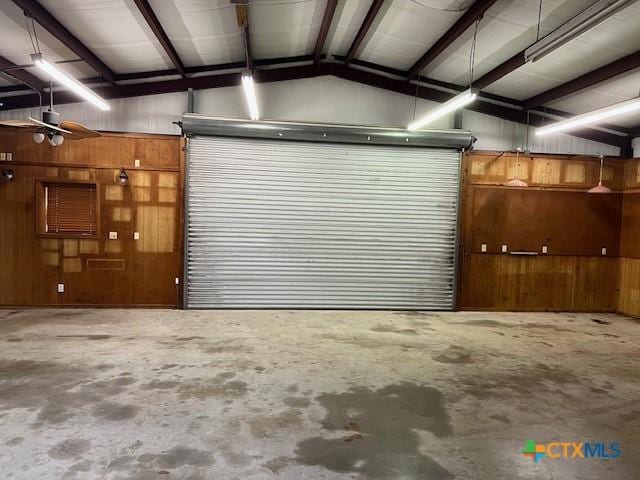 garage featuring wood walls