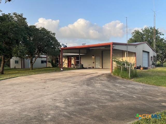 manufactured / mobile home featuring a front yard and a carport