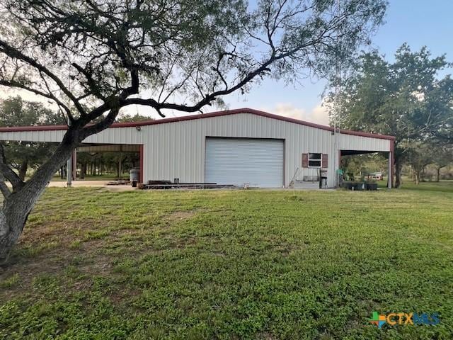 garage featuring a lawn