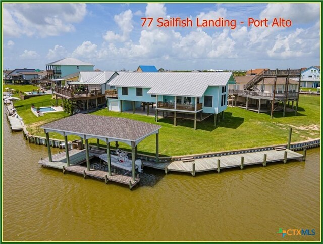 77 Sailfish Lndg, Port Lavaca, TX 77979 - dock with a residential view, a lawn, boat lift, and a deck with water view