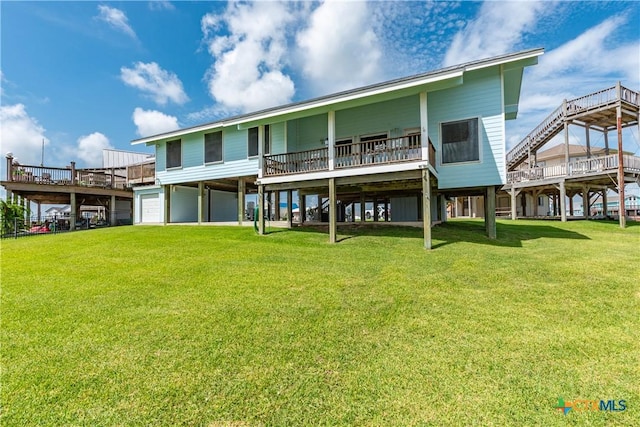 77 Sailfish Lndg, Port Lavaca, TX 77979 - back of property with a yard, a deck, and an attached garage