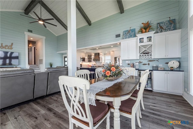77 Sailfish Lndg, Port Lavaca, TX 77979 - dining area featuring wooden walls, dark wood-style flooring, ceiling fan, and bar