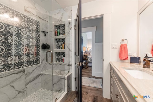 77 Sailfish Lndg, Port Lavaca, TX 77979 - ensuite bathroom featuring vanity, a marble finish shower, and wood finished floors