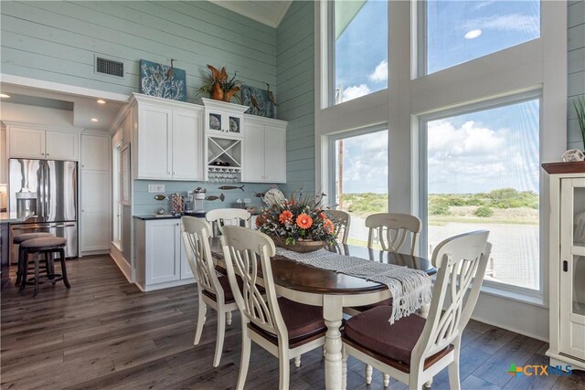 77 Sailfish Lndg, Port Lavaca, TX 77979 - dining room with a high ceiling, dark wood-style floors, and wood walls