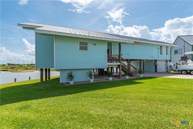 77 Sailfish Lndg, Port Lavaca, TX 77979 - view of front of house with a front lawn, driveway, a water view, and stairway
