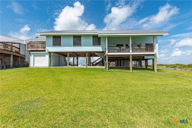 77 Sailfish Lndg, Port Lavaca, TX 77979 - back of property featuring a carport, a lawn, a deck, and a metal roof