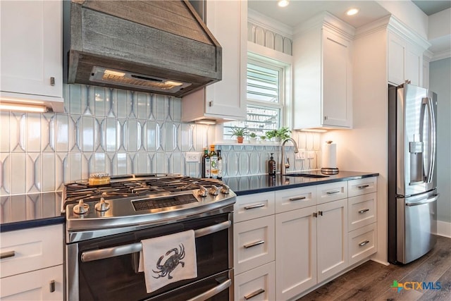 77 Sailfish Lndg, Port Lavaca, TX 77979 - kitchen featuring stainless steel appliances, custom range hood, dark countertops, white cabinetry, and dark wood-type flooring