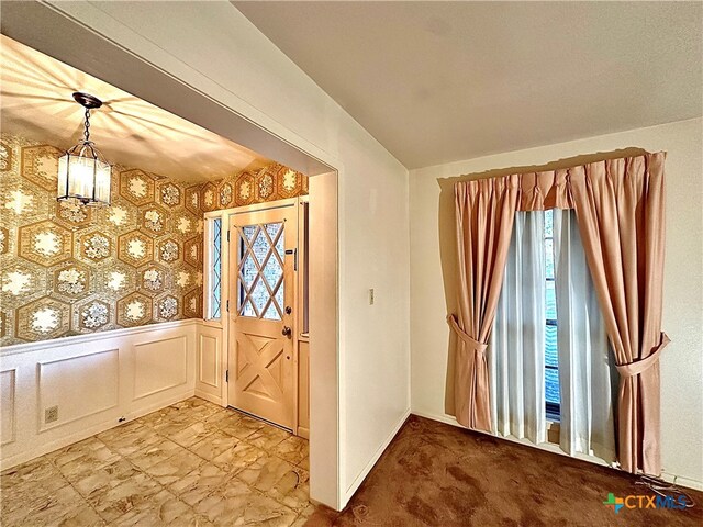 foyer with an inviting chandelier