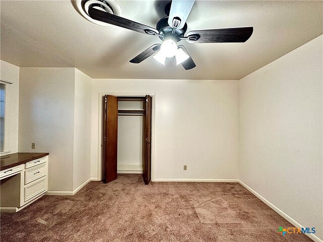 unfurnished bedroom with ceiling fan, light carpet, and a closet