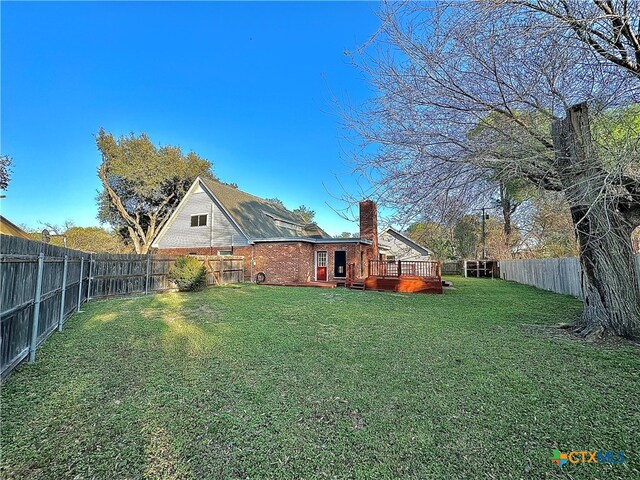 view of yard with a wooden deck