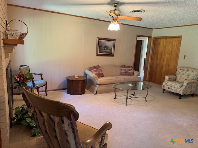 living room with carpet flooring, a textured ceiling, and wooden walls