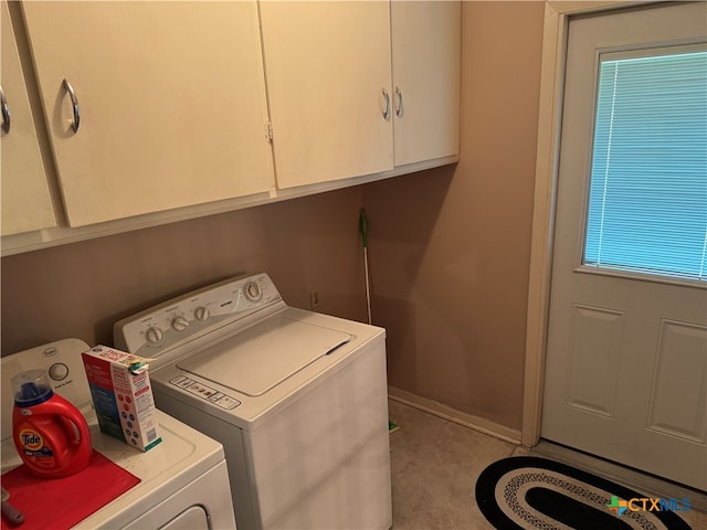 laundry room with cabinets and washing machine and clothes dryer