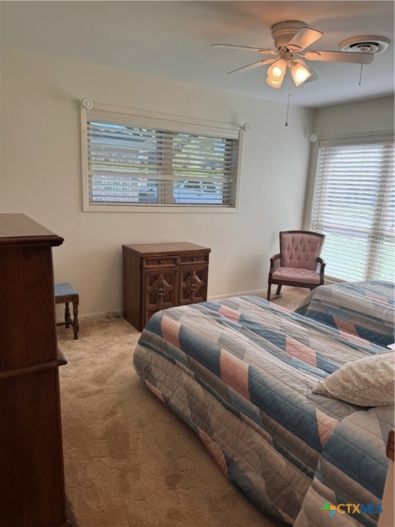 bedroom with light carpet and ceiling fan