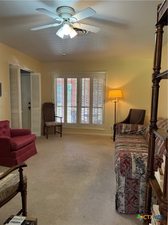 bedroom with ceiling fan and light carpet