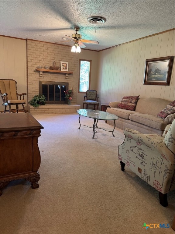 living room with carpet, a brick fireplace, ceiling fan, and wooden walls