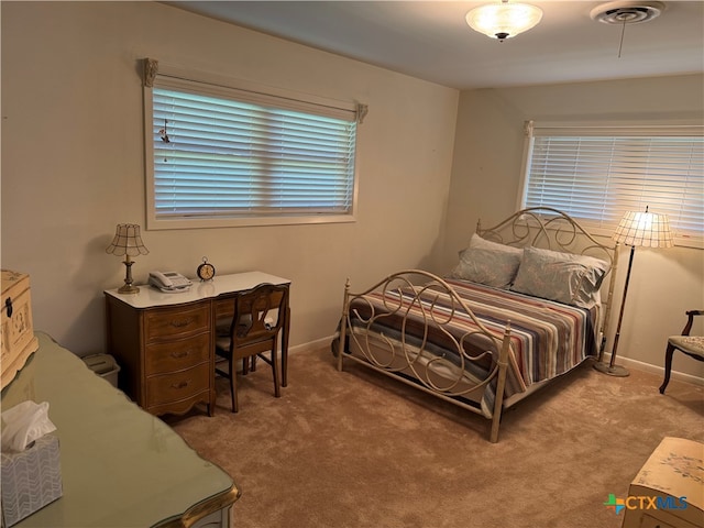 bedroom featuring light colored carpet