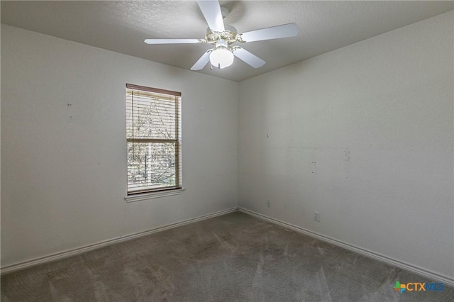 carpeted empty room with a textured ceiling, a ceiling fan, and baseboards