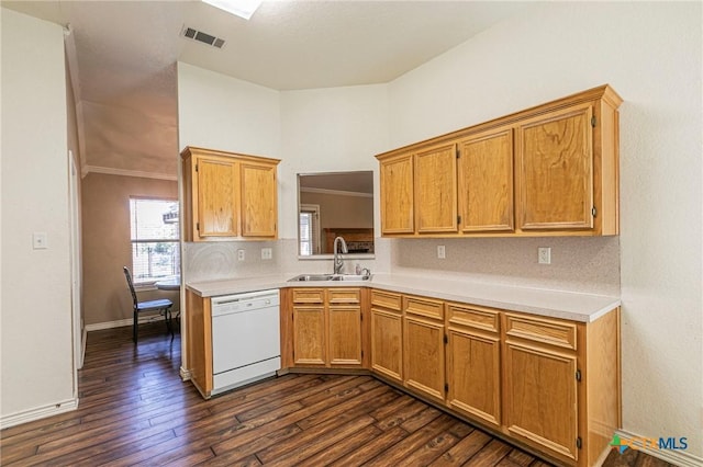 kitchen featuring dishwasher, light countertops, a sink, and dark wood finished floors