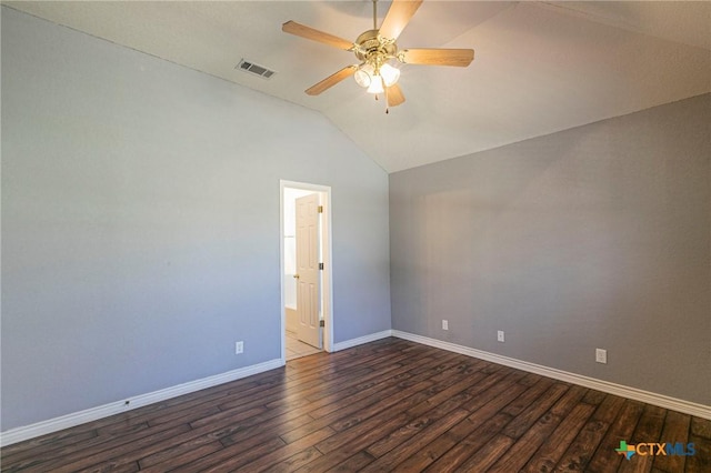 empty room featuring baseboards, visible vents, dark wood-style floors, ceiling fan, and vaulted ceiling