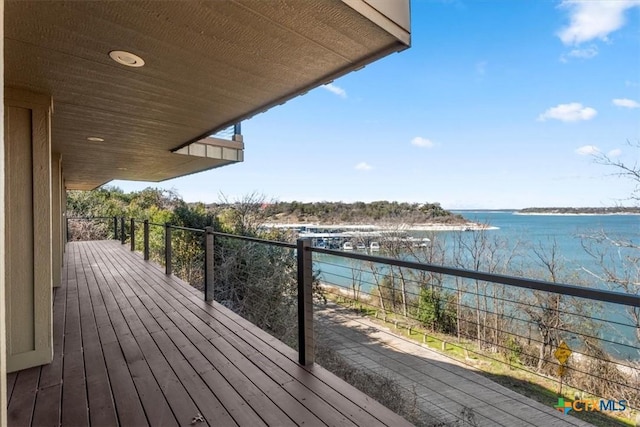 wooden deck featuring a water view