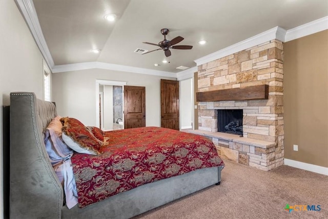 carpeted bedroom with a stone fireplace, vaulted ceiling, ornamental molding, and ceiling fan