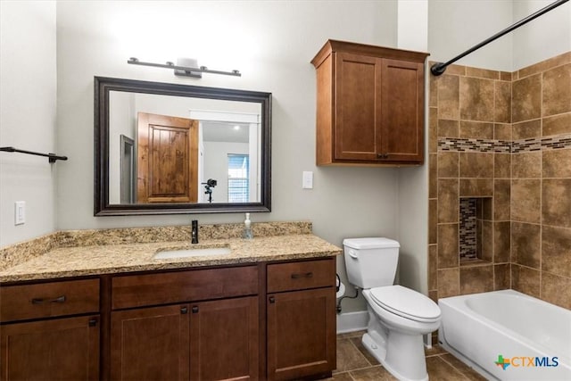 full bathroom with vanity, tiled shower / bath, tile patterned floors, and toilet