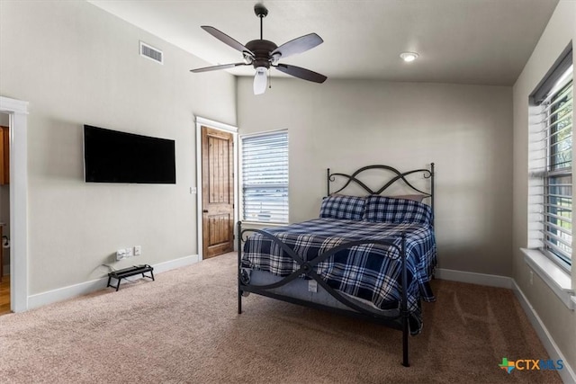 bedroom with ceiling fan, carpet flooring, and multiple windows