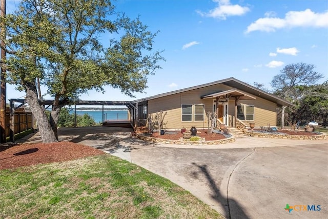 view of front of home with a water view and a carport