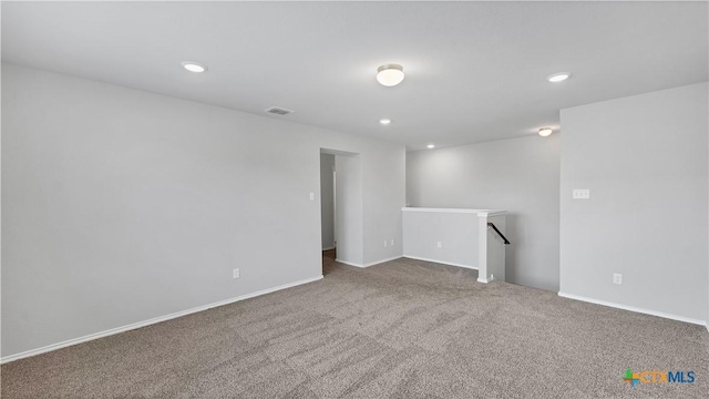 carpeted empty room featuring baseboards and recessed lighting