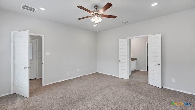 unfurnished bedroom featuring carpet floors, recessed lighting, and visible vents